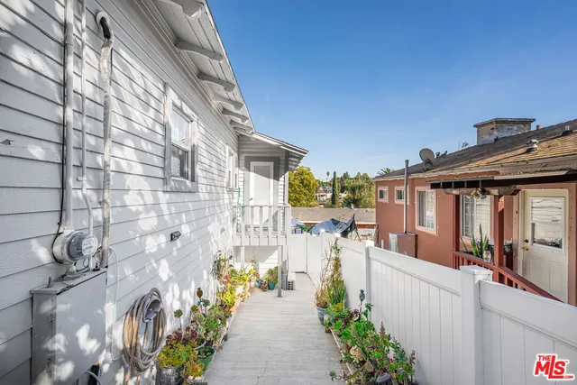 a view of a patio with couches and potted plants