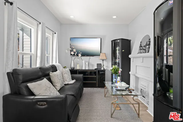 a living room with furniture fireplace and flat screen tv