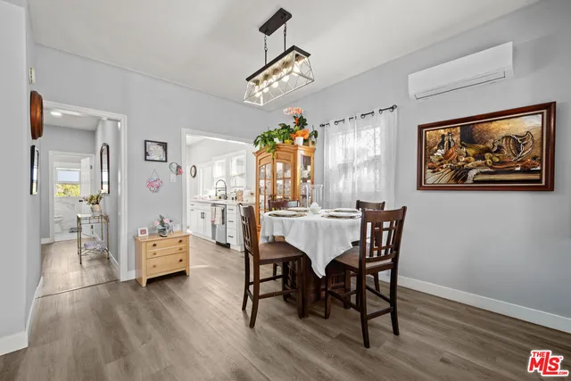 a view of a dining room with furniture wooden floor and a chandelier