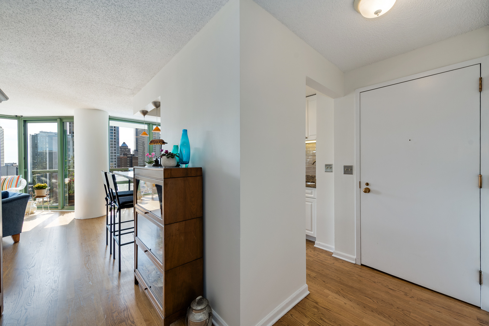 111 West Maple Street, Unit 1601 Chicago, IL 60610 - Photo 14 of 24 a view of a hallway with wooden floor and dining room