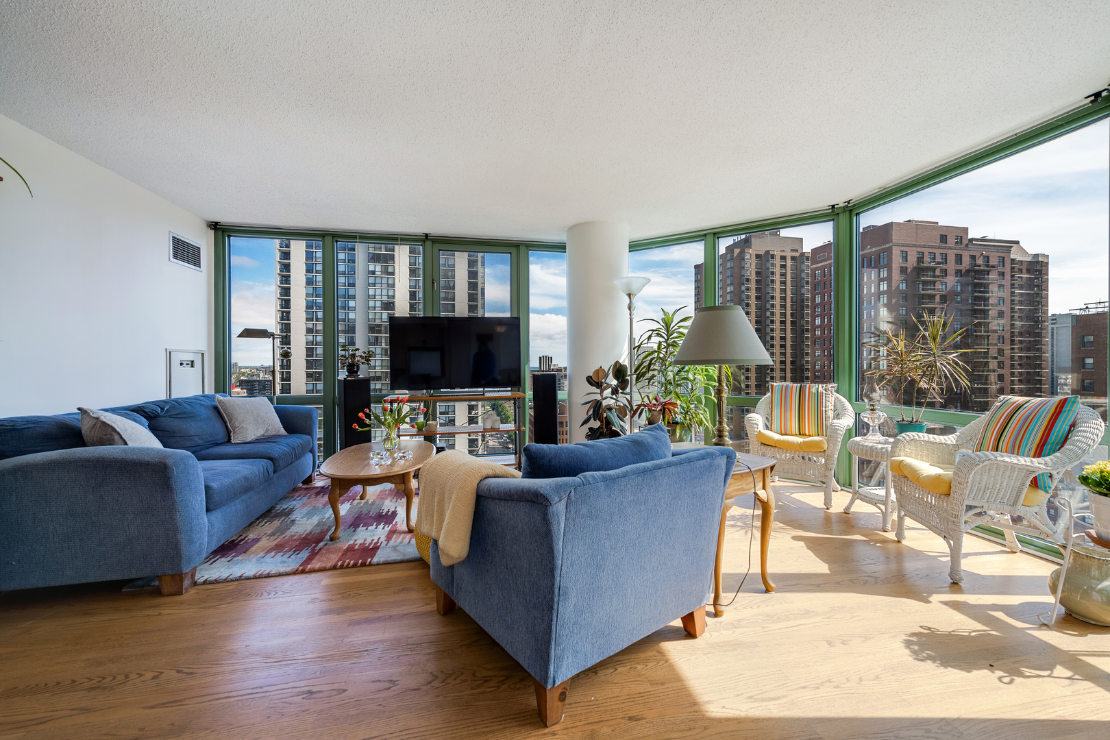 111 West Maple Street, Unit 1601 Chicago, IL 60610 - Photo 5 of 24 a living room with furniture large windows and a flat screen tv