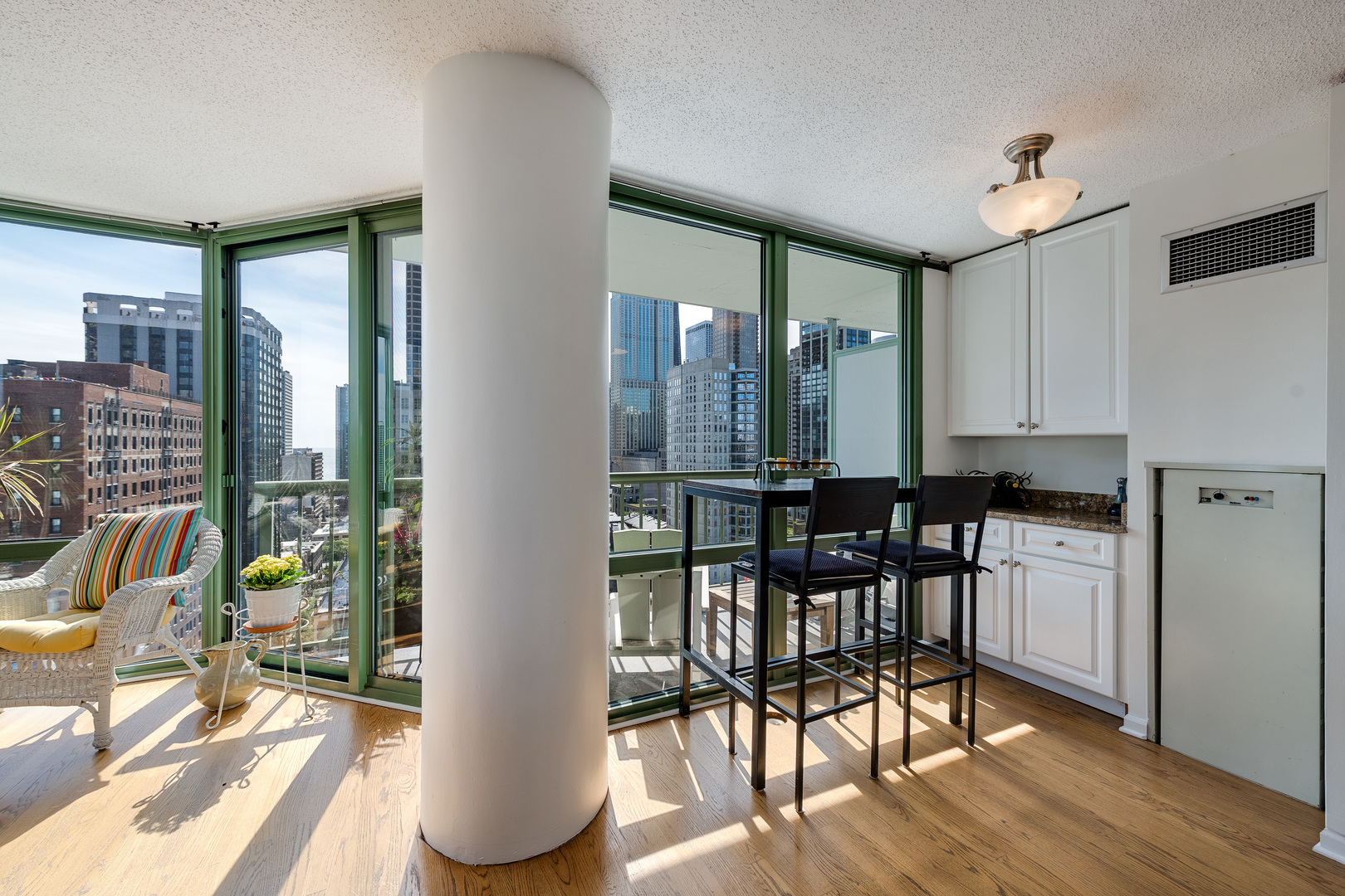 111 West Maple Street, Unit 1601 Chicago, IL 60610 - Photo 9 of 24 a view of a dining room with furniture and wooden floor