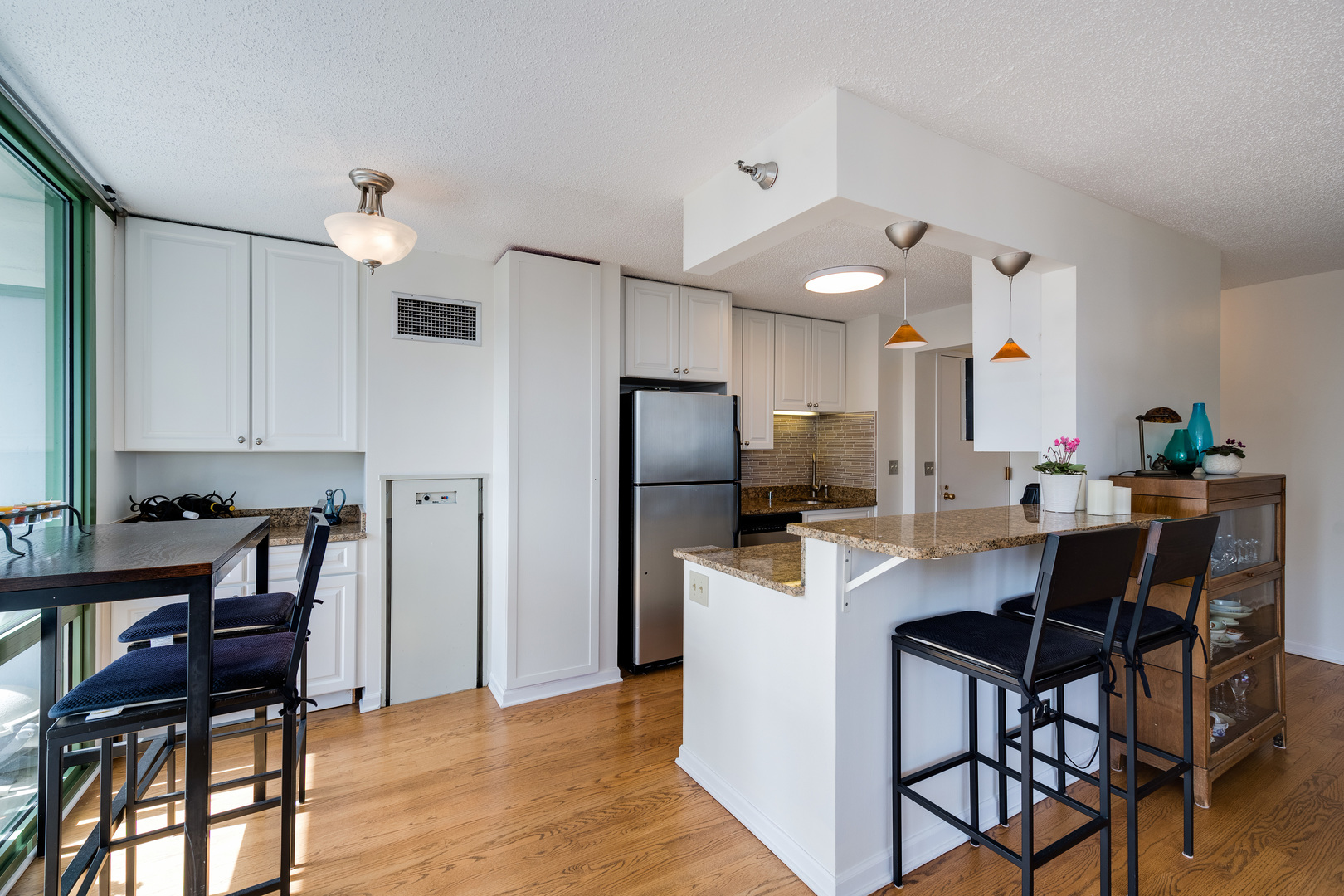 111 West Maple Street, Unit 1601 Chicago, IL 60610 - Photo 10 of 24 a view of kitchen with cabinets table and chairs