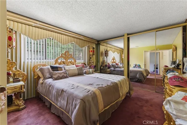 a bedroom with bed and large windows