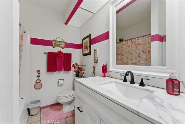 a bathroom with a sink mirror vanity and toilet