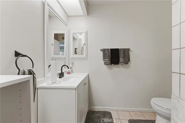 a bathroom with a sink toilet and mirror