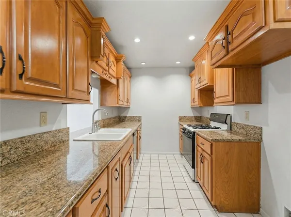 a kitchen with a sink stove and cabinets