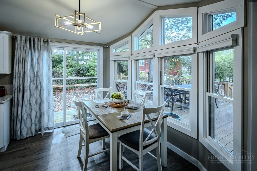 88 Trillium Road Newland, NC 28657 - Photo 20 of 44 a view of a dining room with furniture a chandelier and wooden floor
