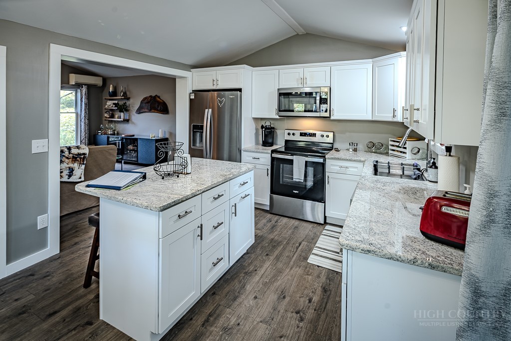 88 Trillium Road Newland, NC 28657 - Photo 24 of 44 a kitchen with granite countertop a sink cabinets and stainless steel appliances