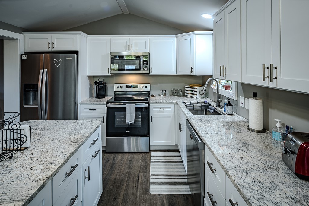 88 Trillium Road Newland, NC 28657 - Photo 25 of 44 a kitchen with stainless steel appliances granite countertop a sink stove and refrigerator