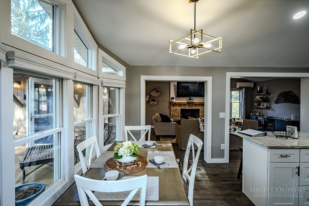 88 Trillium Road Newland, NC 28657 - Photo 26 of 44 a view of a dining room with furniture large window and wooden floor