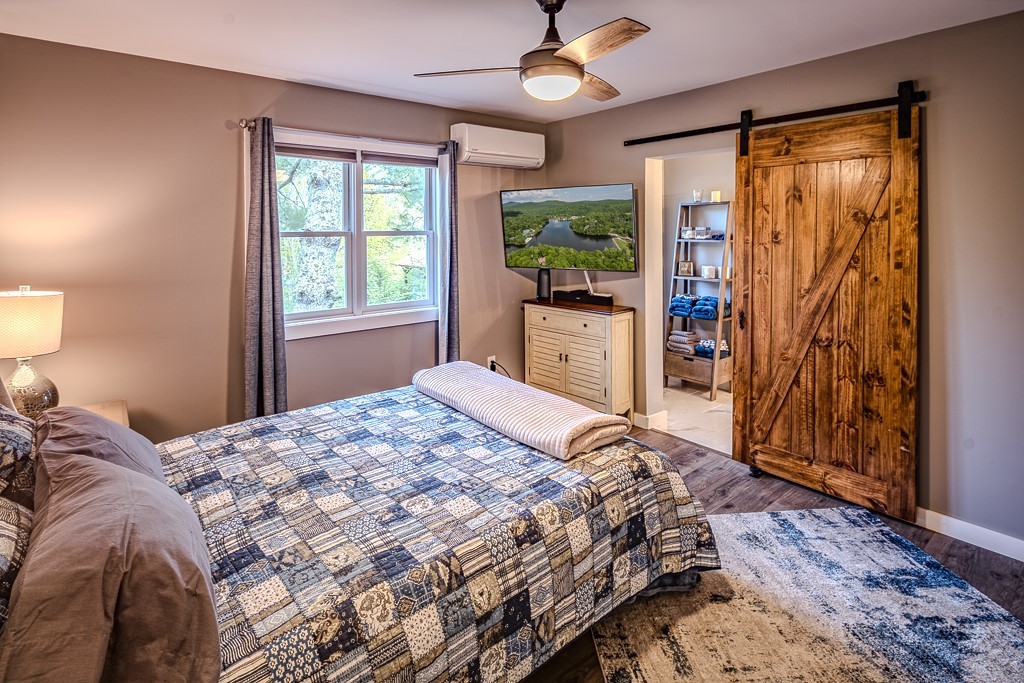 88 Trillium Road Newland, NC 28657 - Photo 28 of 44 a bed sitting in a bedroom next to a window