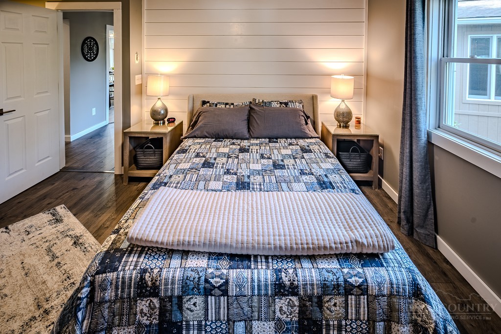 88 Trillium Road Newland, NC 28657 - Photo 30 of 44 a bedroom with a bed and wooden floor