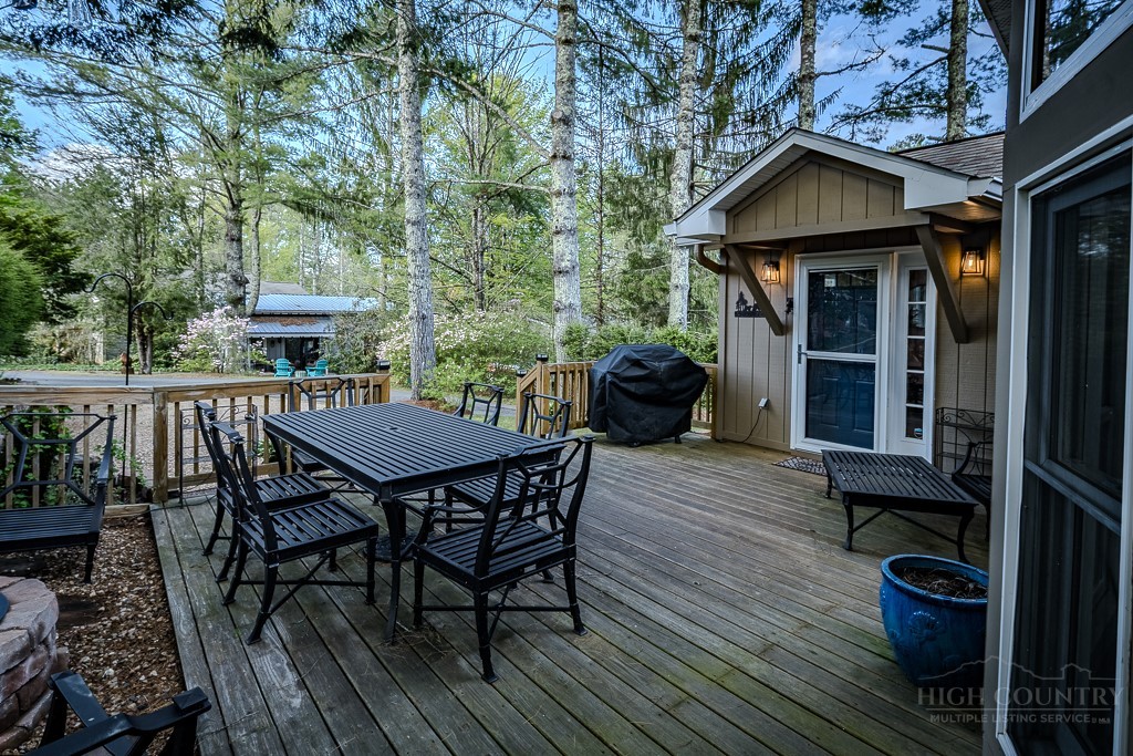 88 Trillium Road Newland, NC 28657 - Photo 3 of 44 a view of a wooden chairs and table on the wooden floor