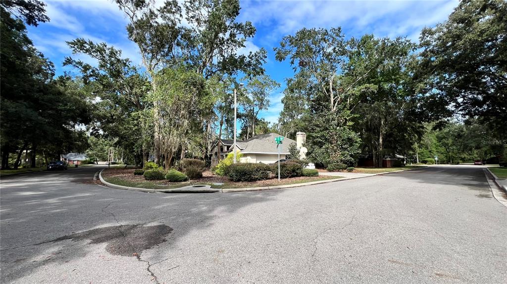 4305 Northwest 55 Way Gainesville, FL 32606 - Photo 3 of 14 a view of a street with a house and trees in the background