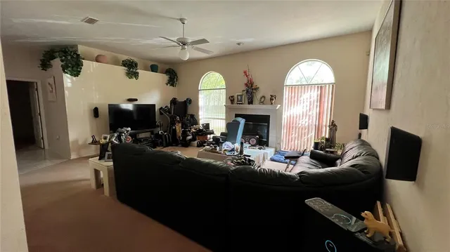 a living room with fireplace furniture and a fireplace