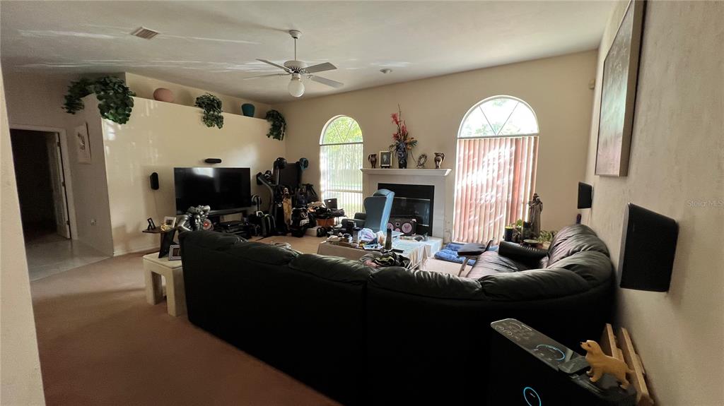 4305 Northwest 55 Way Gainesville, FL 32606 - Photo 8 of 14 a living room with fireplace furniture and a fireplace