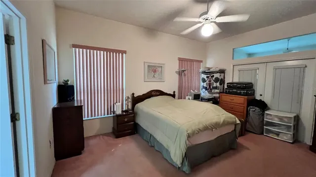a spacious bedroom with a bed and a chandelier