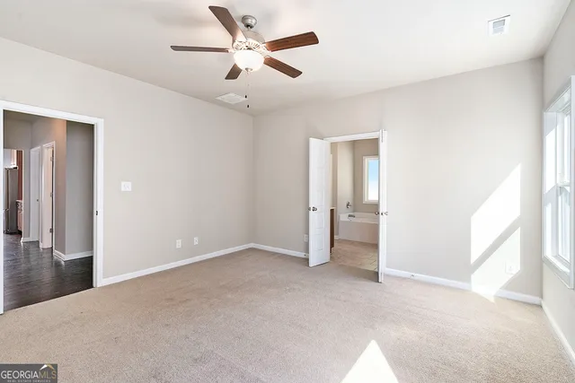 a view of an empty room and closet area