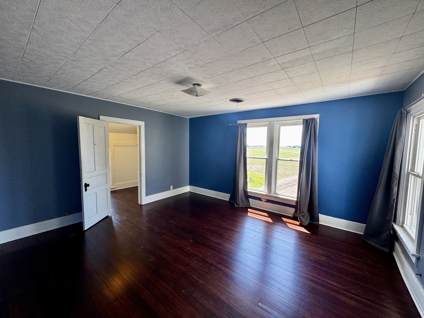 16606 West Backbone Road Princeton, IL 61356 - Photo 20 of 40 an empty room with wooden floor and windows