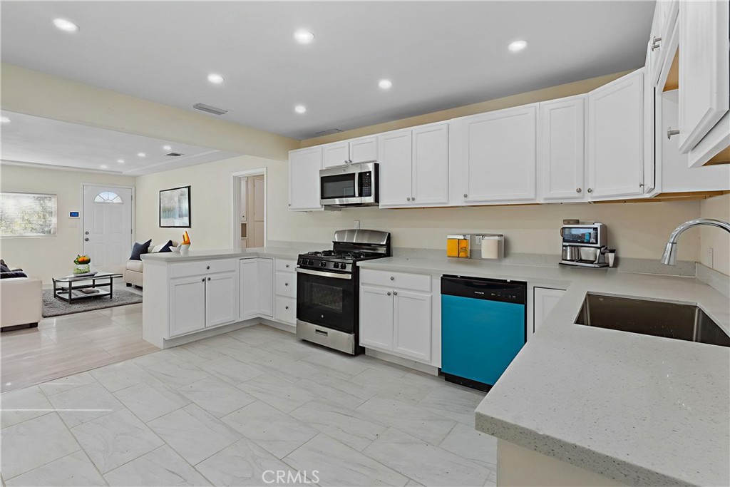 224 South Alessandro Street Hemet, CA 92543 - Photo 1 of 32 a kitchen with a sink a stove top oven and white cabinets