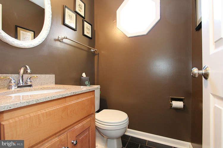 11525 Pine Cone Court Reston, VA 20191 - Photo 13 of 30 a bathroom with a granite countertop toilet sink and mirror