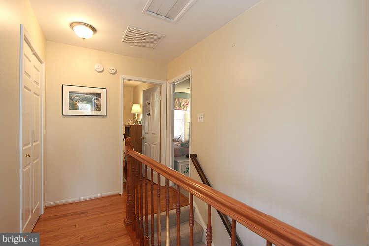 11525 Pine Cone Court Reston, VA 20191 - Photo 14 of 30 a view of a hallway with paintings on the wall