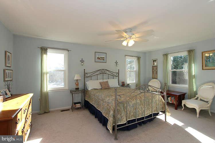 11525 Pine Cone Court Reston, VA 20191 - Photo 18 of 30 a bedroom with a bed and a chandelier