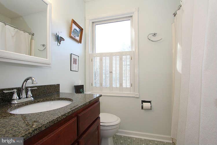 11525 Pine Cone Court Reston, VA 20191 - Photo 21 of 30 a bathroom with a granite countertop sink toilet and a mirror