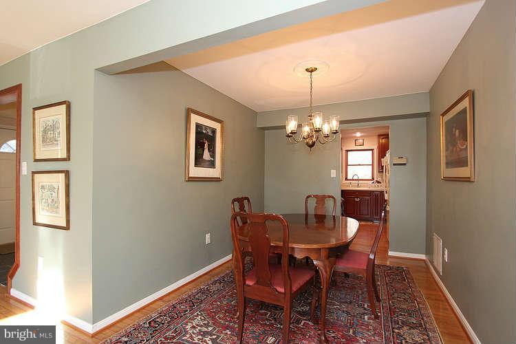 11525 Pine Cone Court Reston, VA 20191 - Photo 6 of 30 a dining room with furniture and chandelier
