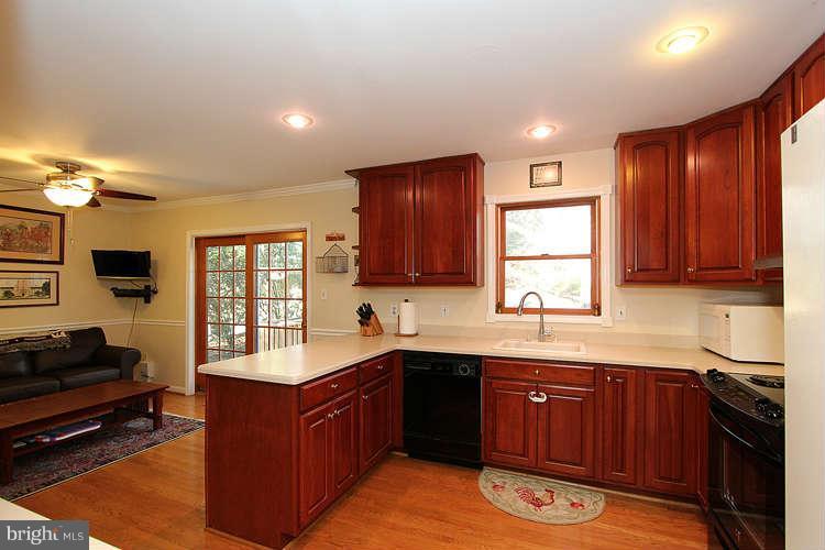 11525 Pine Cone Court Reston, VA 20191 - Photo 7 of 30 a kitchen with stainless steel appliances granite countertop wooden cabinets a stove a sink and a window