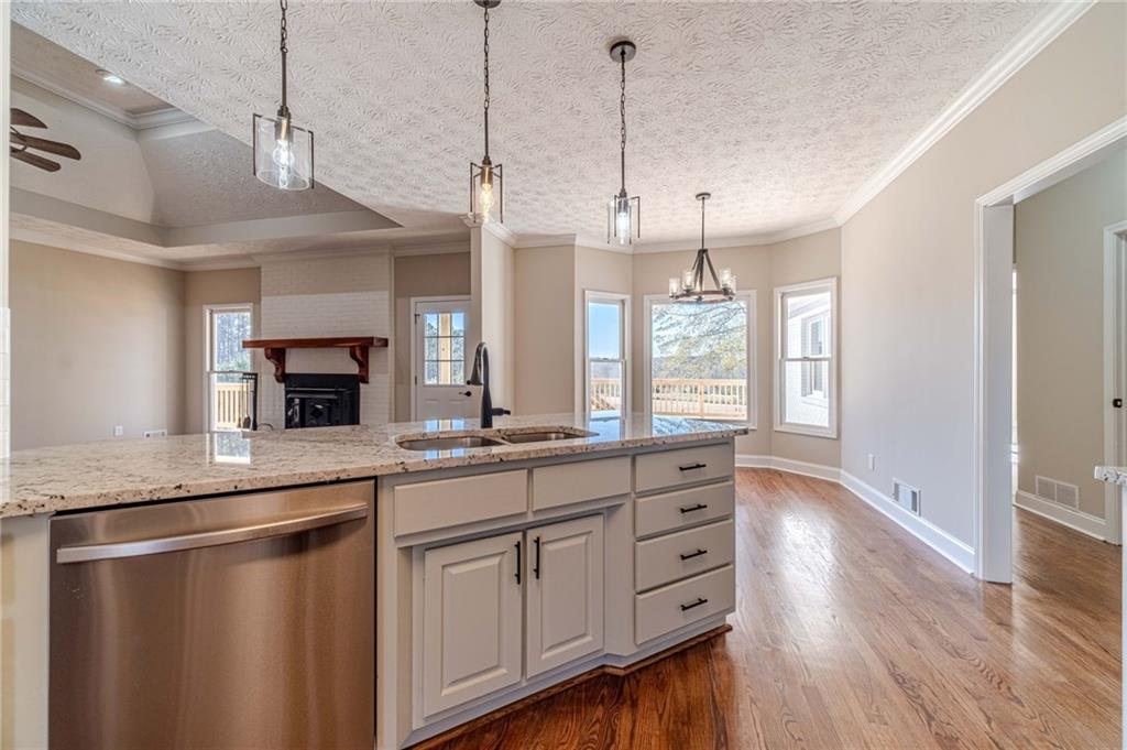 710 Youth Jersey Road Monroe, GA 30655 - Photo 17 of 53 a kitchen with stainless steel appliances granite countertop a sink a window a refrigerator and wooden floor