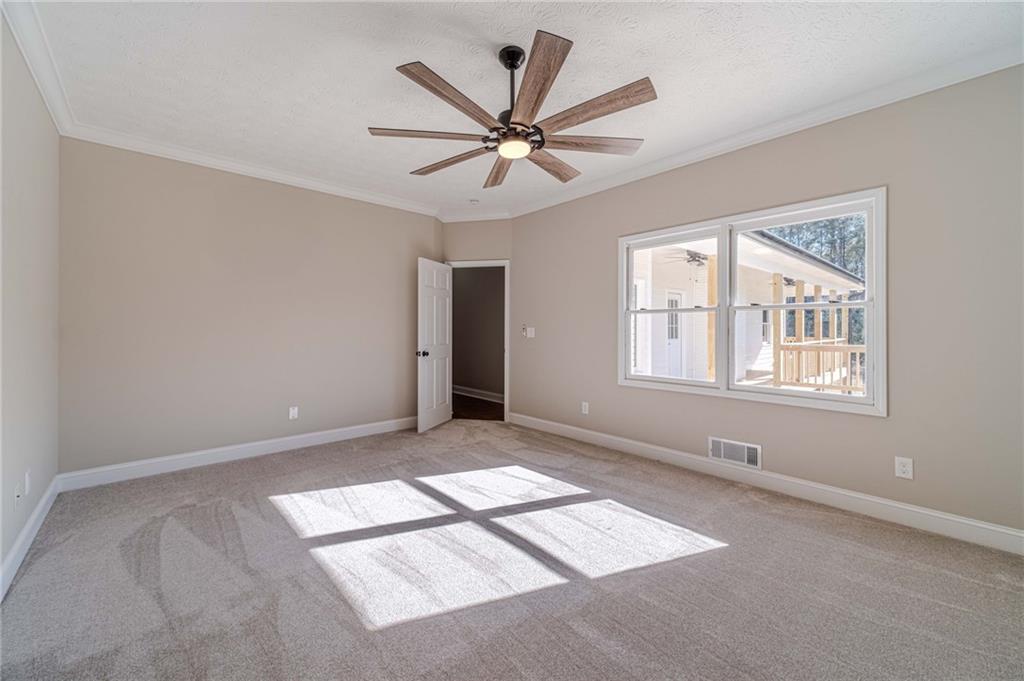 710 Youth Jersey Road Monroe, GA 30655 - Photo 27 of 53 an empty room with windows and ceiling fan