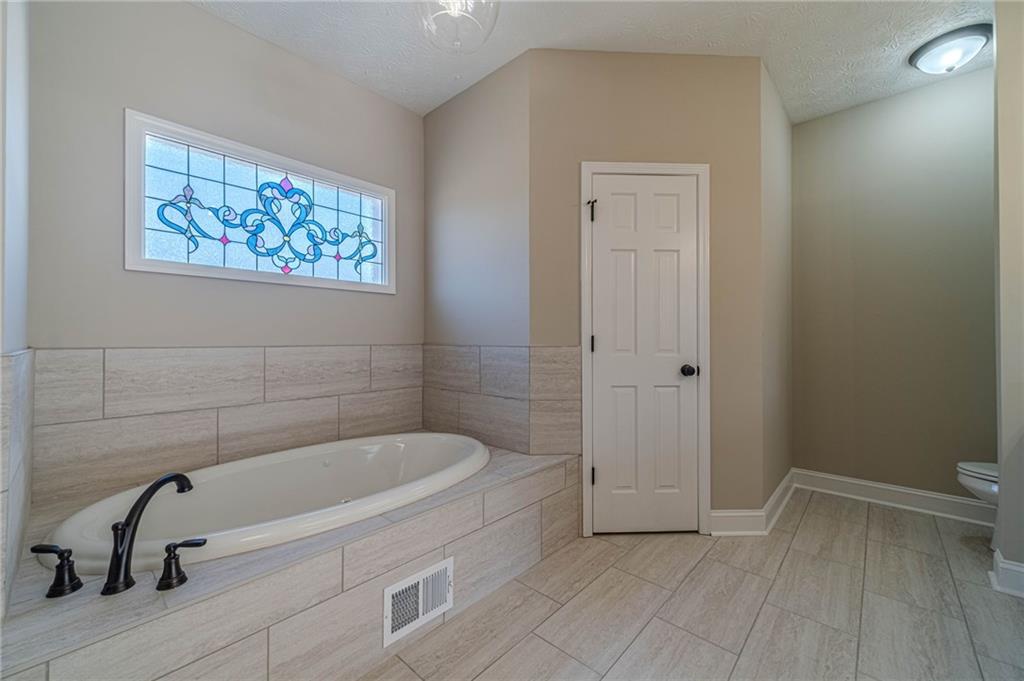 710 Youth Jersey Road Monroe, GA 30655 - Photo 31 of 53 a bathroom with a bathtub and a shower