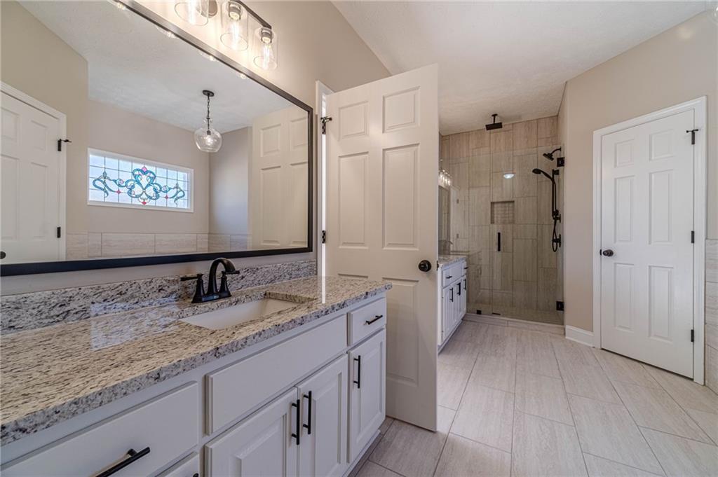 710 Youth Jersey Road Monroe, GA 30655 - Photo 33 of 53 a spacious bathroom with a granite countertop sink mirror and a