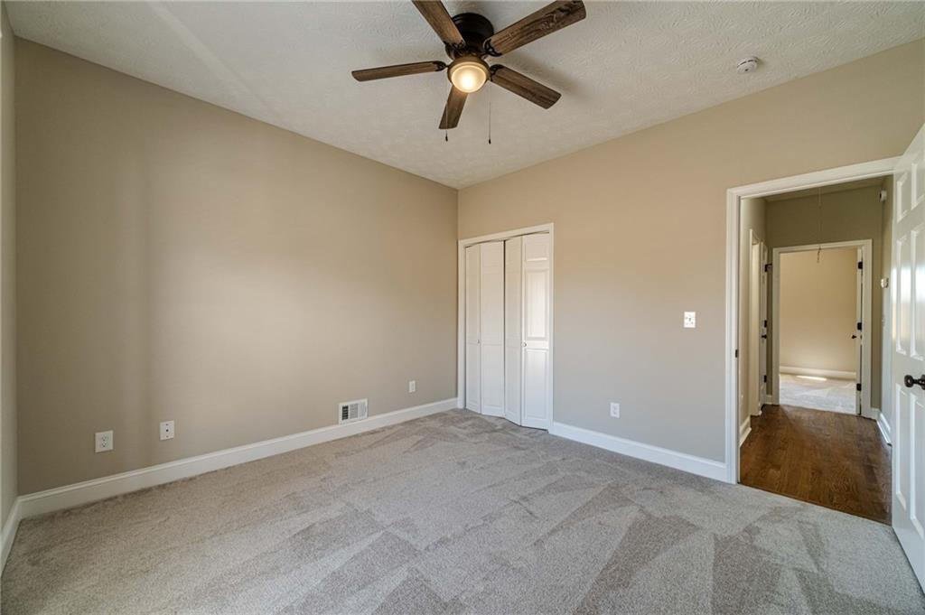 710 Youth Jersey Road Monroe, GA 30655 - Photo 37 of 53 a view of a room with a ceiling fan and hardwood floor