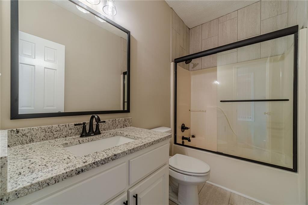 710 Youth Jersey Road Monroe, GA 30655 - Photo 39 of 53 a bathroom with a granite countertop sink toilet and shower