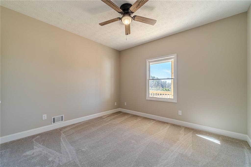 710 Youth Jersey Road Monroe, GA 30655 - Photo 40 of 53 an empty room with a window and a fan