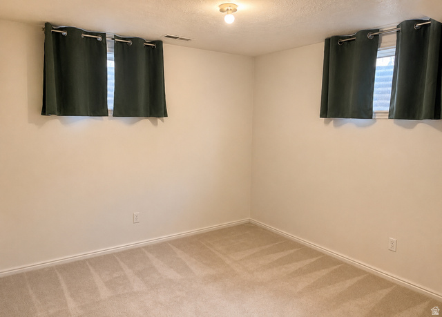 1020 Wilmar Place Centerville, UT 84014 - Photo 14 of 22 Carpeted room with neutral wall tones and two windows featuring drapery