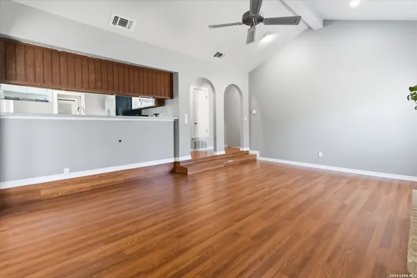 a kitchen with stainless steel appliances granite countertop white cabinets and a sink