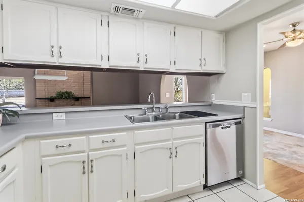 a kitchen with stainless steel appliances a refrigerator sink and microwave