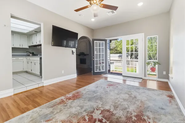 a view of livingroom with kitchen view and an empty room
