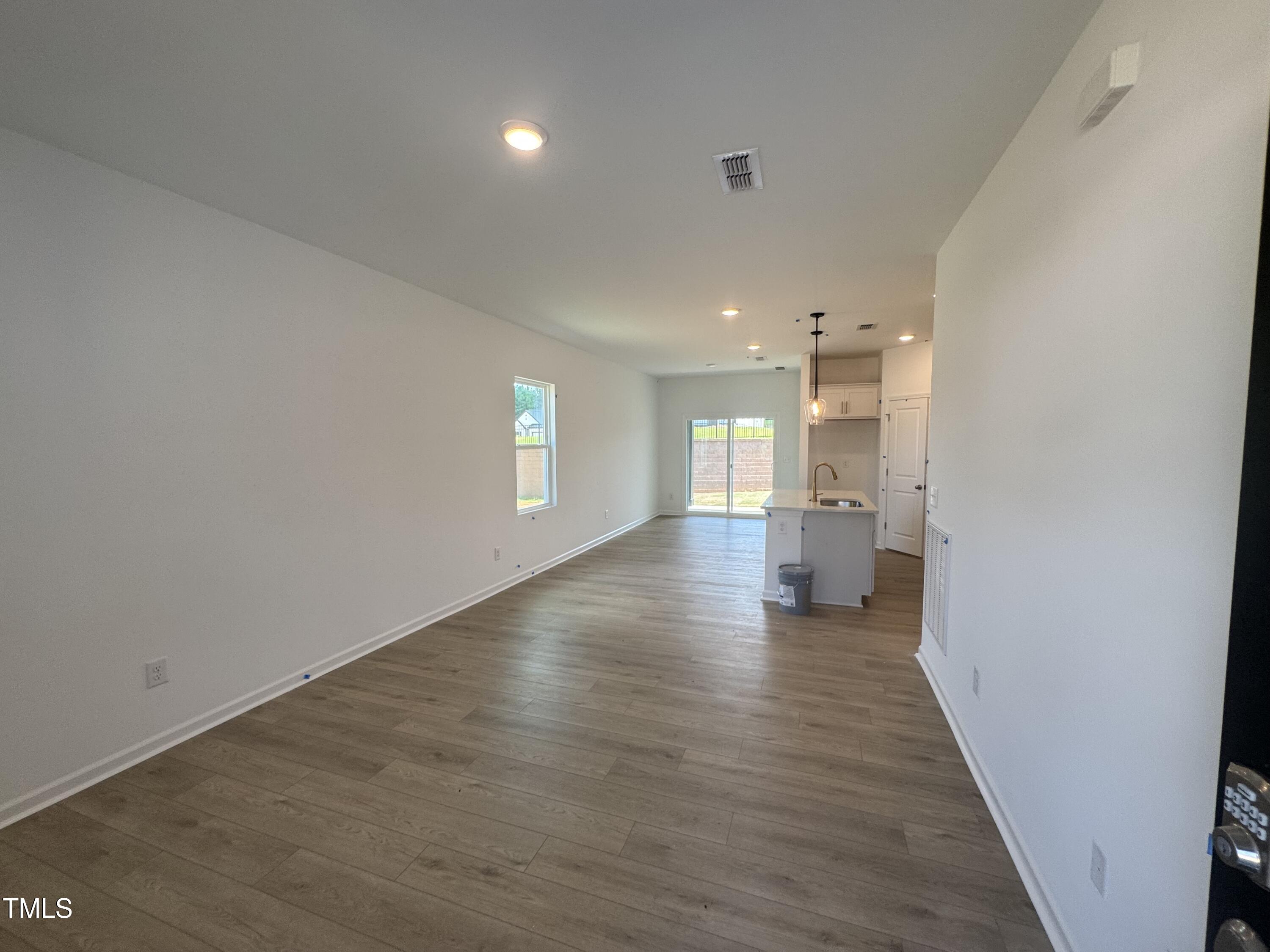 11739 Salers Loop Middlesex, NC 27557 - Photo 3 of 24 a view of a hallway with wooden floor and a kitchen
