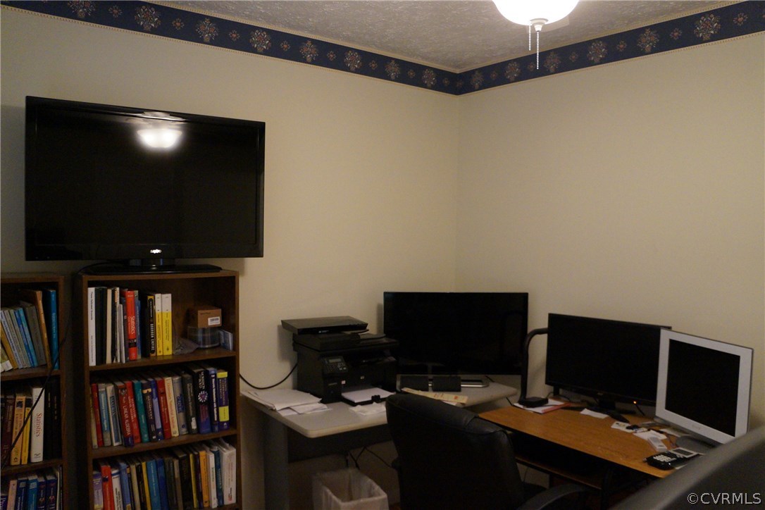 3135 Meherrin Road Meherrin, VA 23954 - Photo 13 of 20 a view of a workspace with furniture and a bookshelf