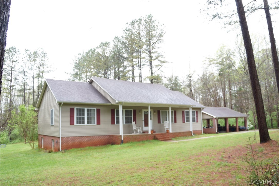 3135 Meherrin Road Meherrin, VA 23954 - Photo 3 of 20 a front view of a house with a garden and trees