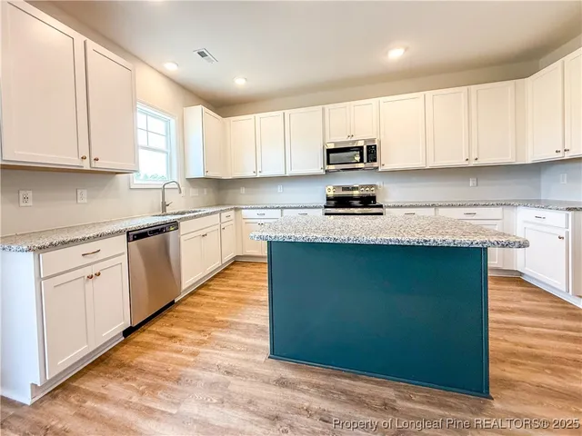 a view of a bedroom with wooden floor and hallway