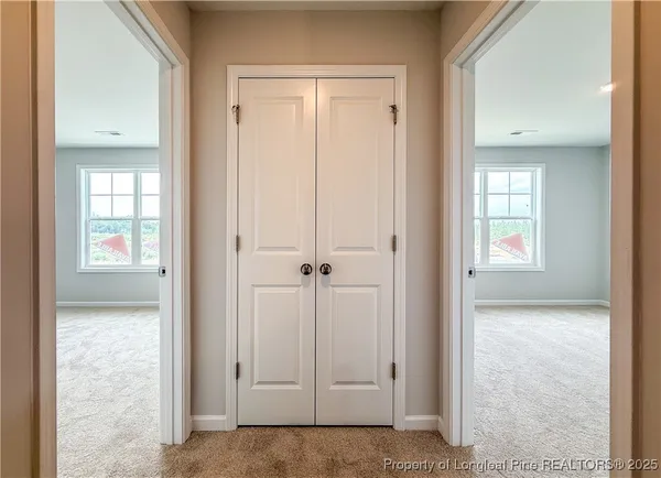 an empty room with windows and closet