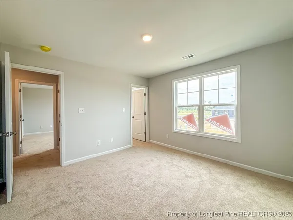 a view of a livingroom with an empty space and a hallway