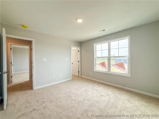 a view of a livingroom with an empty space and a hallway