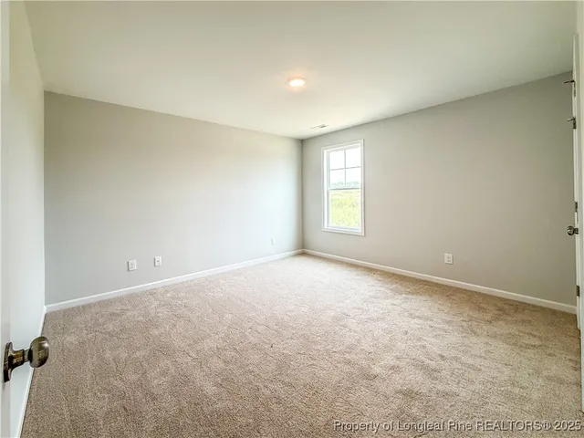 an empty room with a empty space and windows